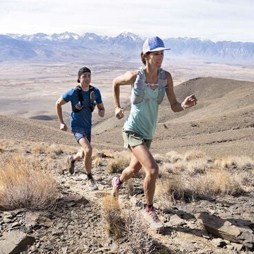 Two runners running up a hill